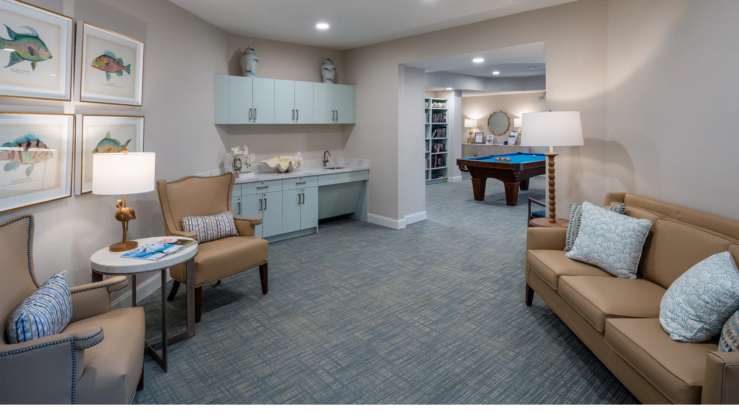lounge with pool table and bookshelves at senior living apartments